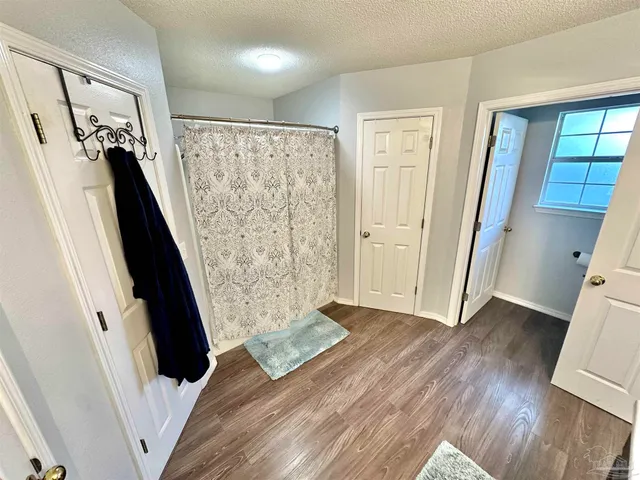 a living room with a bed furniture and a large window