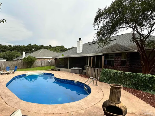 a view of a house with swimming pool and a trees