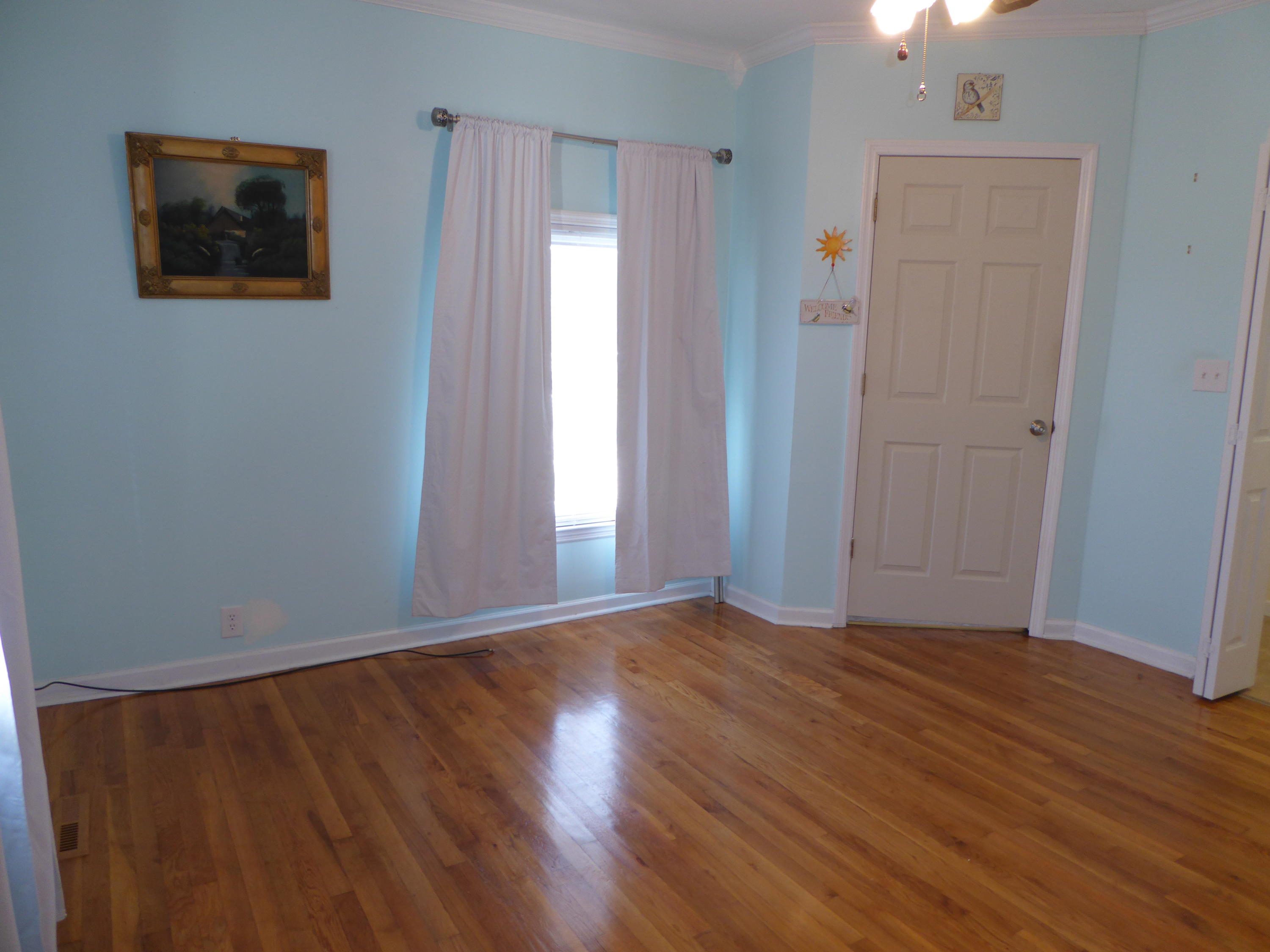 810 Scuffling Hill Road Rocky Mount, VA 24151 - Photo 11 of 52 an empty room with wooden floor and windows