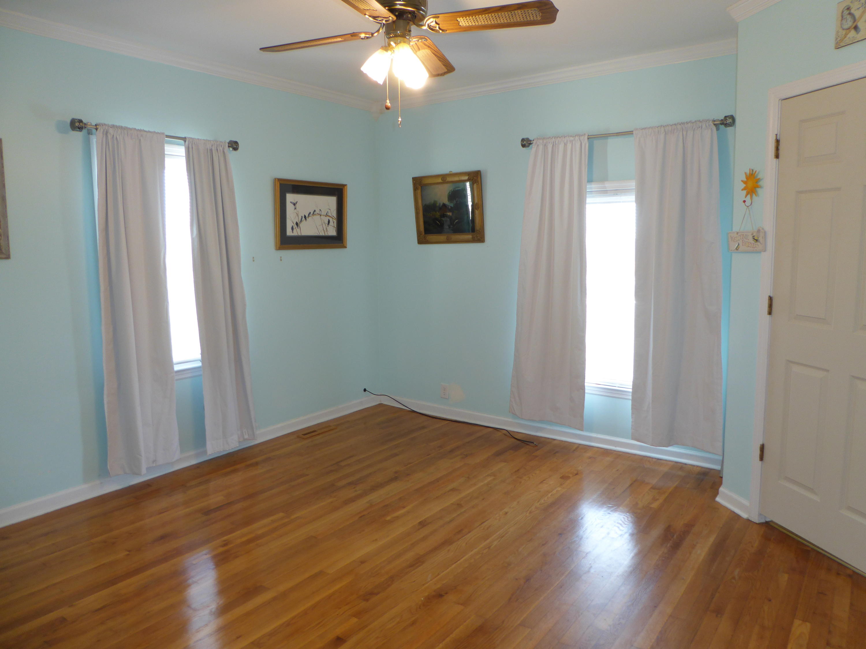 810 Scuffling Hill Road Rocky Mount, VA 24151 - Photo 12 of 52 a view of an empty room with wooden floor and a window