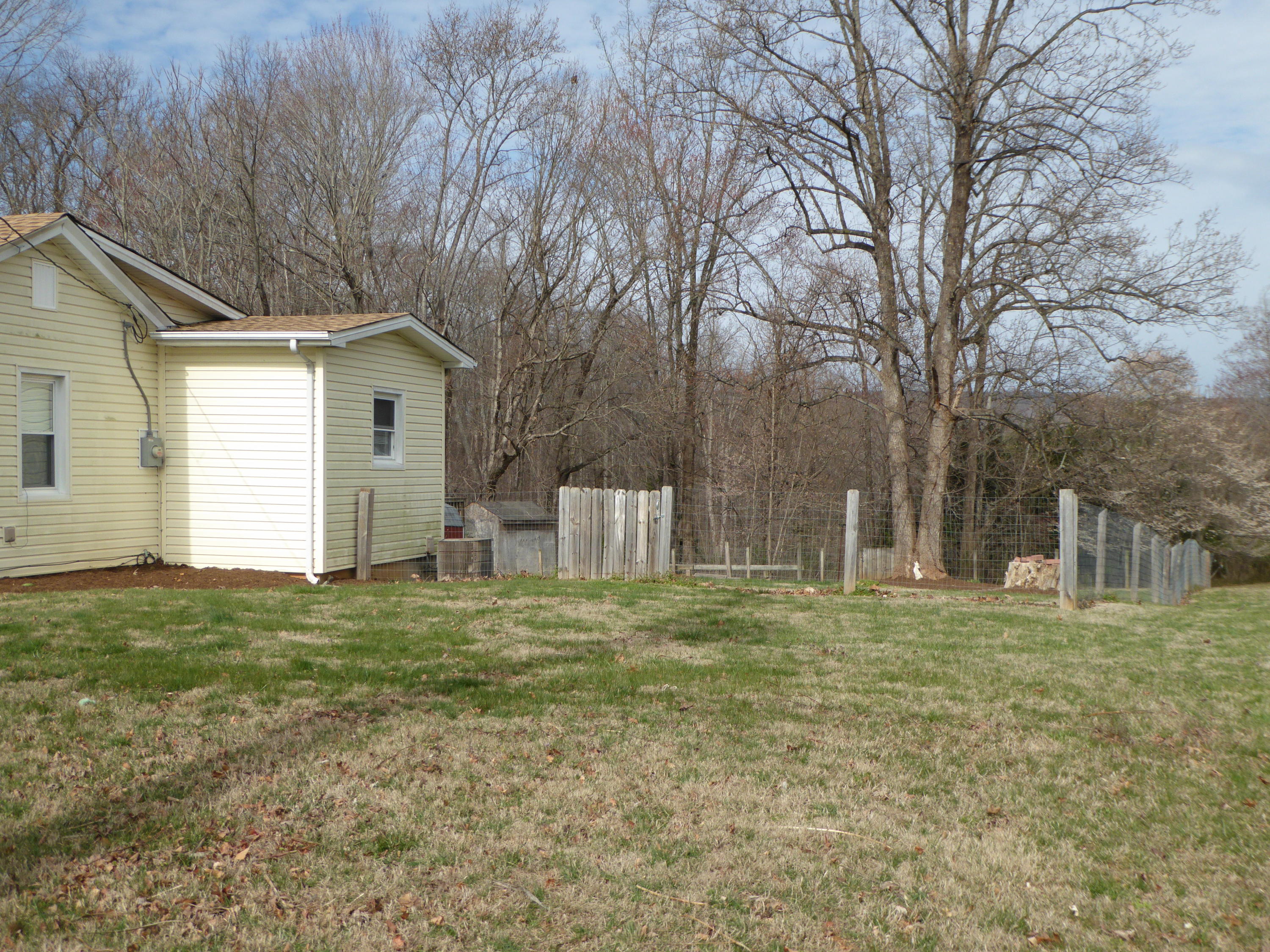 810 Scuffling Hill Road Rocky Mount, VA 24151 - Photo 26 of 52 a white house covered with tall trees