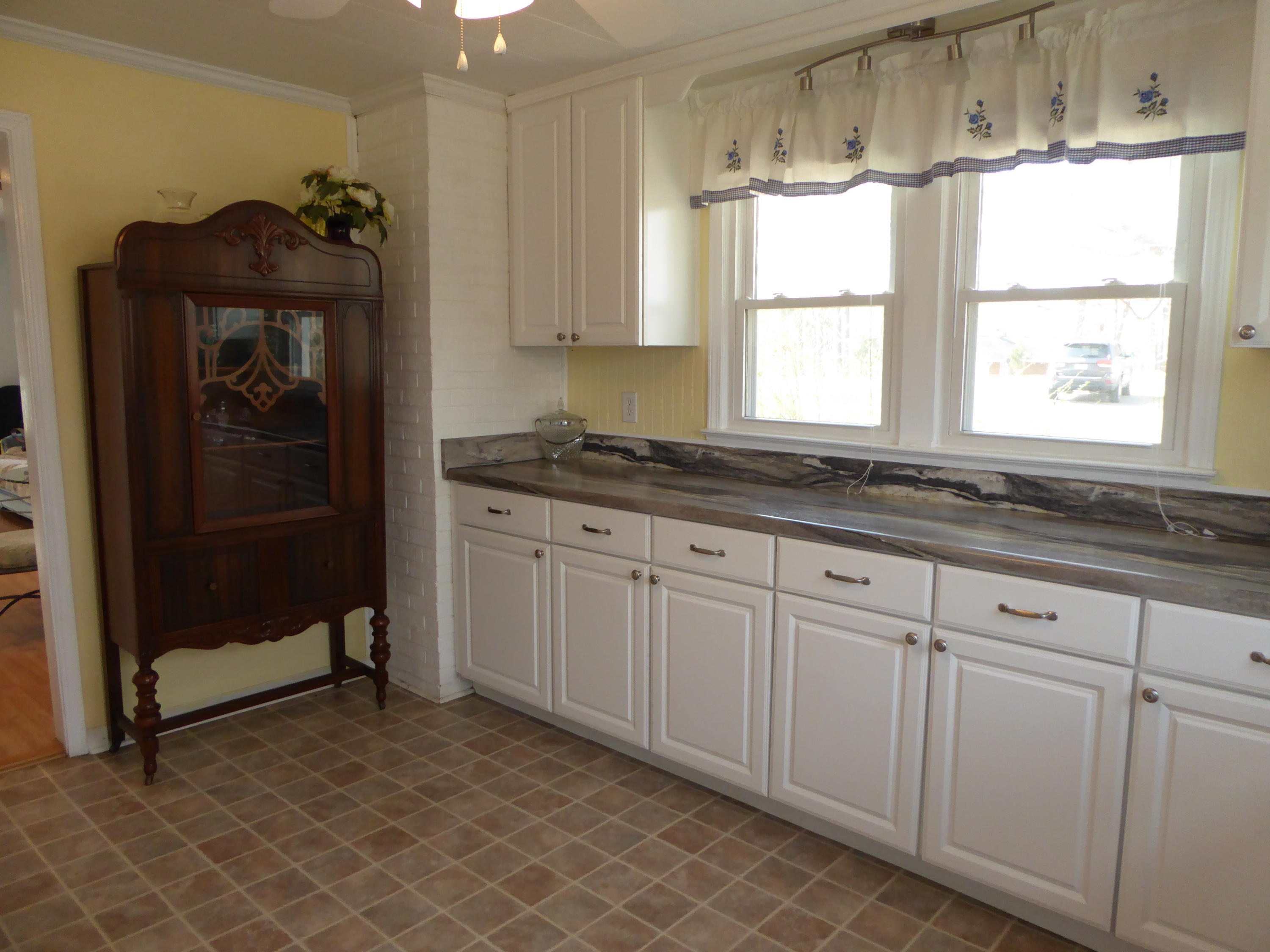 810 Scuffling Hill Road Rocky Mount, VA 24151 - Photo 36 of 52 a kitchen with granite countertop white cabinets and a sink