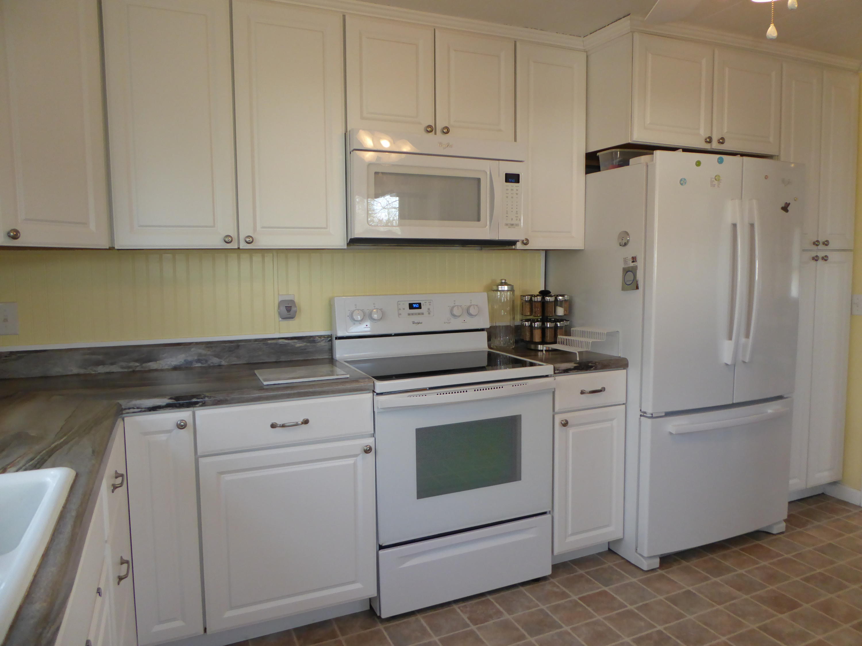 810 Scuffling Hill Road Rocky Mount, VA 24151 - Photo 38 of 52 a kitchen with white cabinets and white appliances