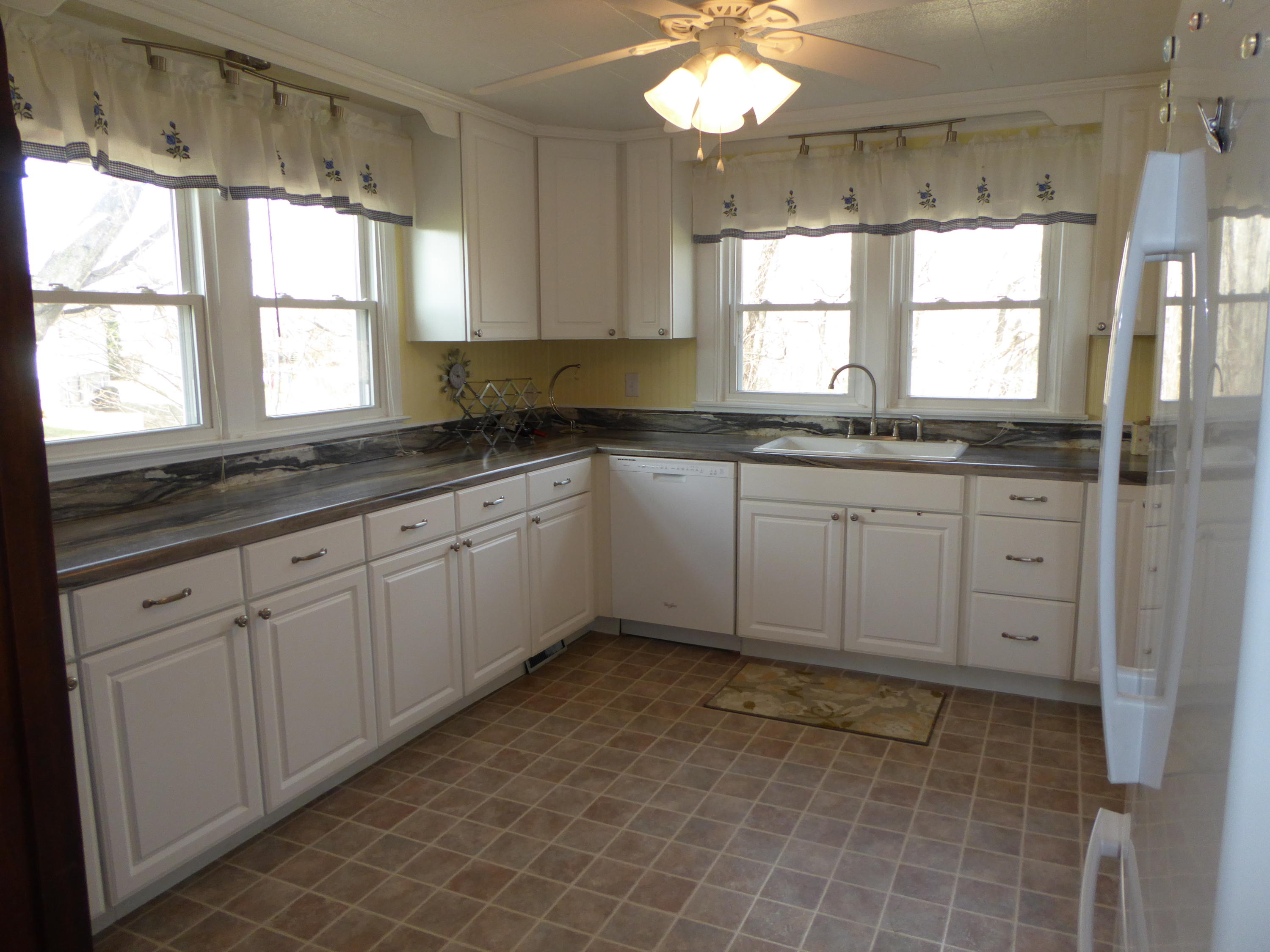 810 Scuffling Hill Road Rocky Mount, VA 24151 - Photo 9 of 52 a kitchen with granite countertop a sink window and cabinets
