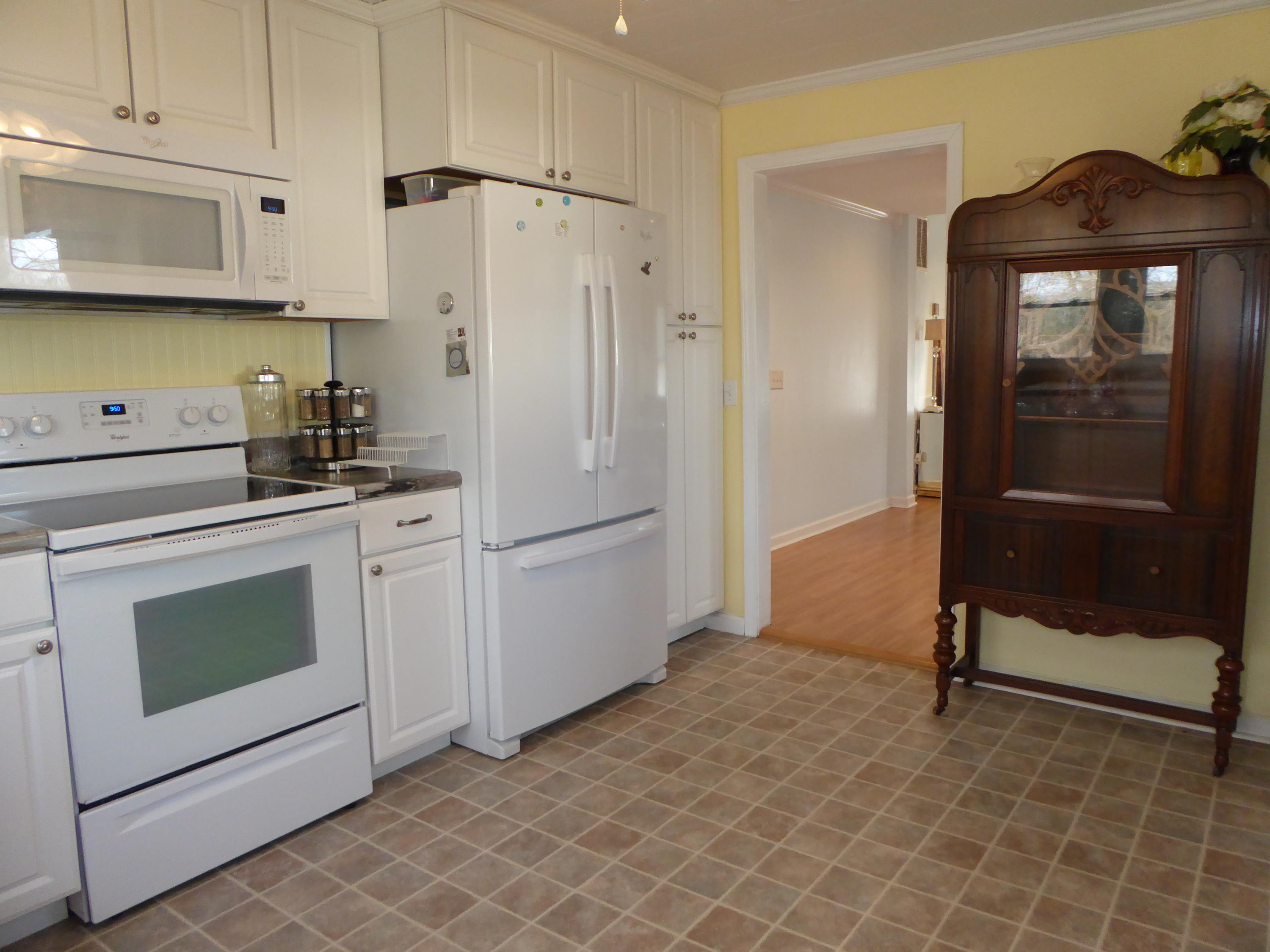 810 Scuffling Hill Road Rocky Mount, VA 24151 - Photo 10 of 52 a kitchen with white cabinets and white appliances