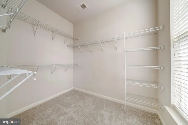 a spacious bathroom with a bathtub shower sink mirror and toilet