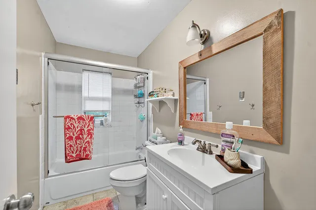 a bathroom with a sink a toilet and a mirror