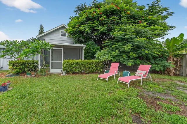 a view of a backyard with sitting area