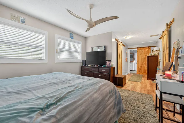 a bedroom with a bed and a flat screen tv