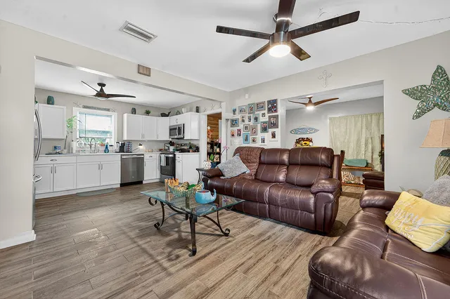 a living room with furniture and kitchen view