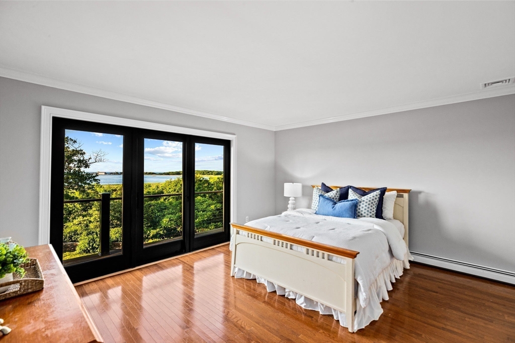 24 Wood Island Road Scituate, MA 02066 - Photo 37 of 42 a bed sitting in a bedroom next to a window
