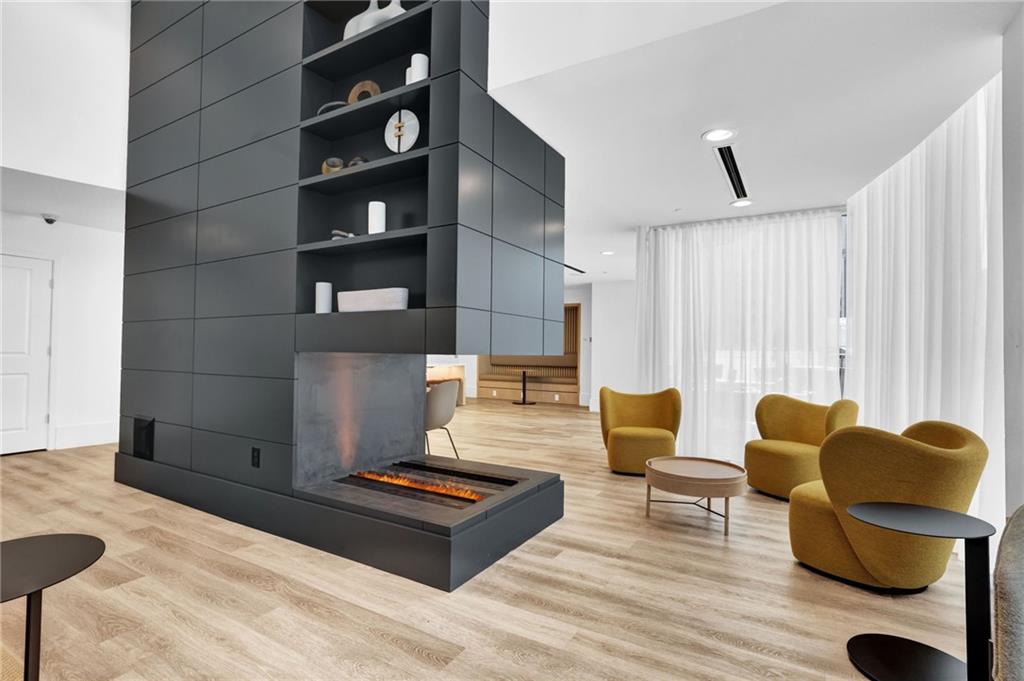 3324 Peachtree Road Northeast, Unit 2507 Atlanta, GA 30326 - Photo 17 of 25 a living room with furniture and wooden floor