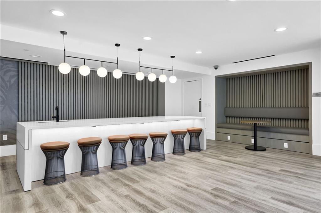 3324 Peachtree Road Northeast, Unit 2507 Atlanta, GA 30326 - Photo 19 of 25 a large room with lots of wooden furniture a sink and stainless steel appliances
