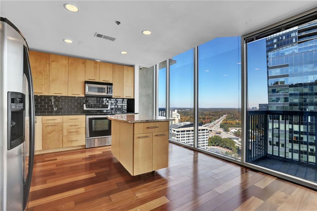 3324 Peachtree Road Northeast, Unit 2507 Atlanta, GA 30326 - Photo 9 of 25 a kitchen with stainless steel appliances a refrigerator sink and microwave