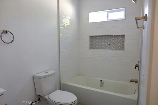 a bathroom with a toilet and a bathtub
