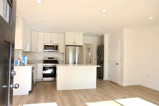 a kitchen with stainless steel appliances a refrigerator sink and microwave