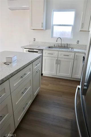 a kitchen with cabinets a sink and appliances