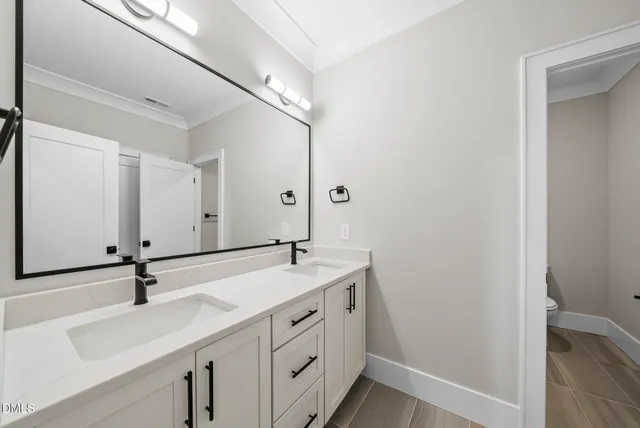 a backyard of a house with garden and outdoor seating