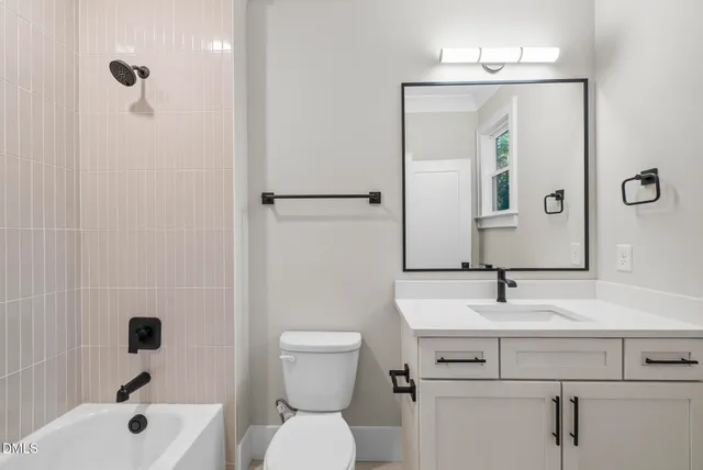 a white house that has a tree in front of it