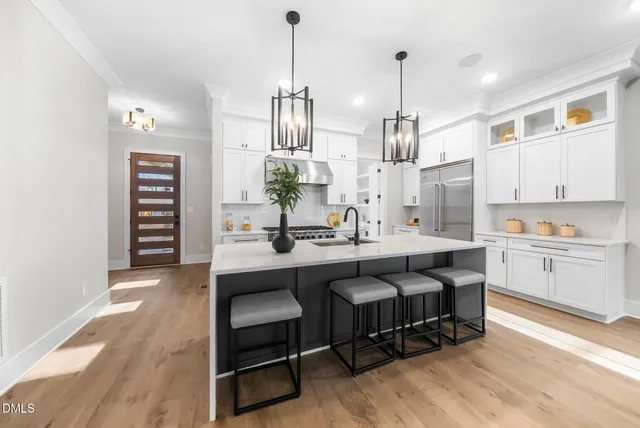 a kitchen with white cabinets and appliances