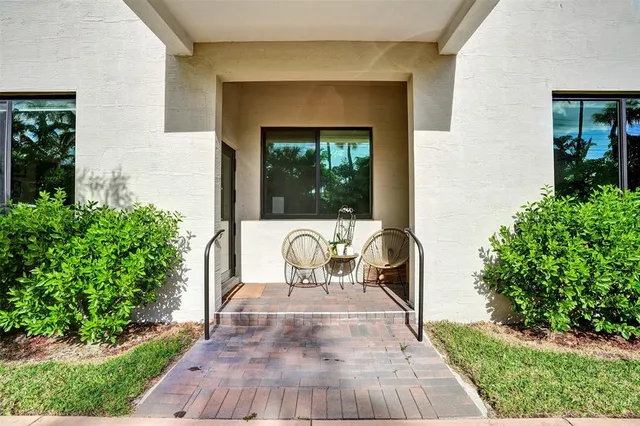 a view of a chair and table in the patio