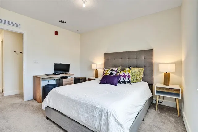 a bedroom with a bed and a lamp