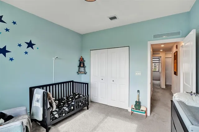 a view of a hallway to a livingroom with furniture