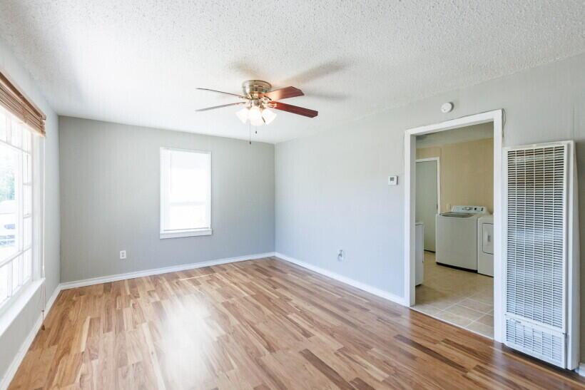 1110 46th Street Lubbock, TX 79412 - Photo 3 of 10 a view of empty room with wooden floor and fan