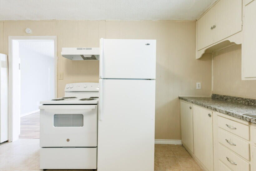 1110 46th Street Lubbock, TX 79412 - Photo 5 of 10 a white refrigerator freezer sitting inside of a kitchen
