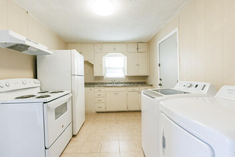 1110 46th Street Lubbock, TX 79412 - Photo 6 of 10 a kitchen with a stove top oven sink and cabinets