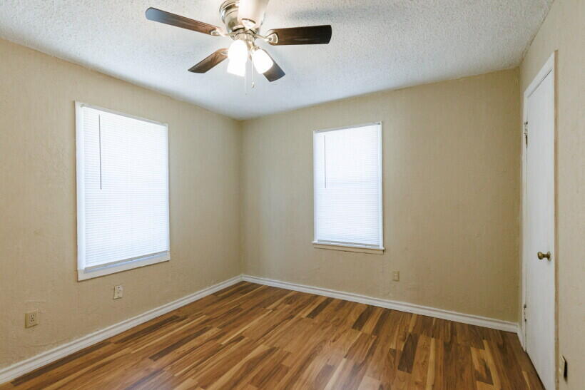 1110 46th Street Lubbock, TX 79412 - Photo 7 of 10 a view of empty room with wooden floor and fan