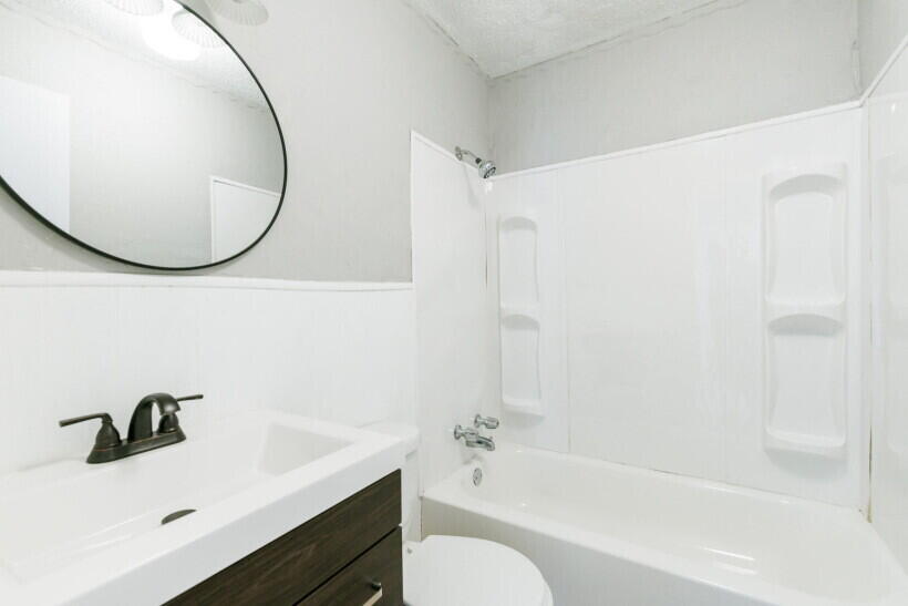 1110 46th Street Lubbock, TX 79412 - Photo 8 of 10 a bathroom with a sink and a mirror