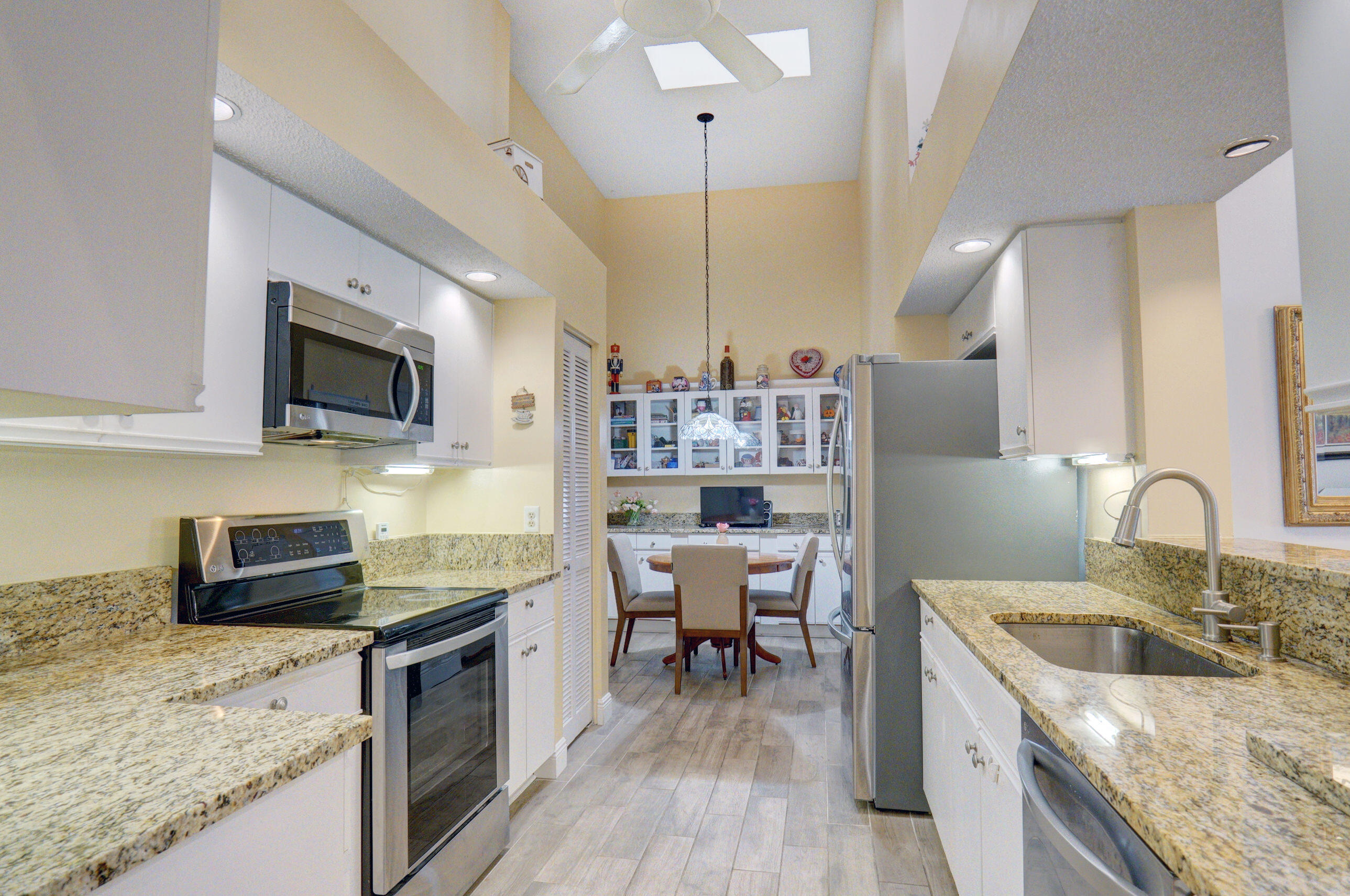 11110 Autoro Court Boca Raton, FL 33498 - Photo 2 of 24 a kitchen with stainless steel appliances granite countertop a sink stove and refrigerator