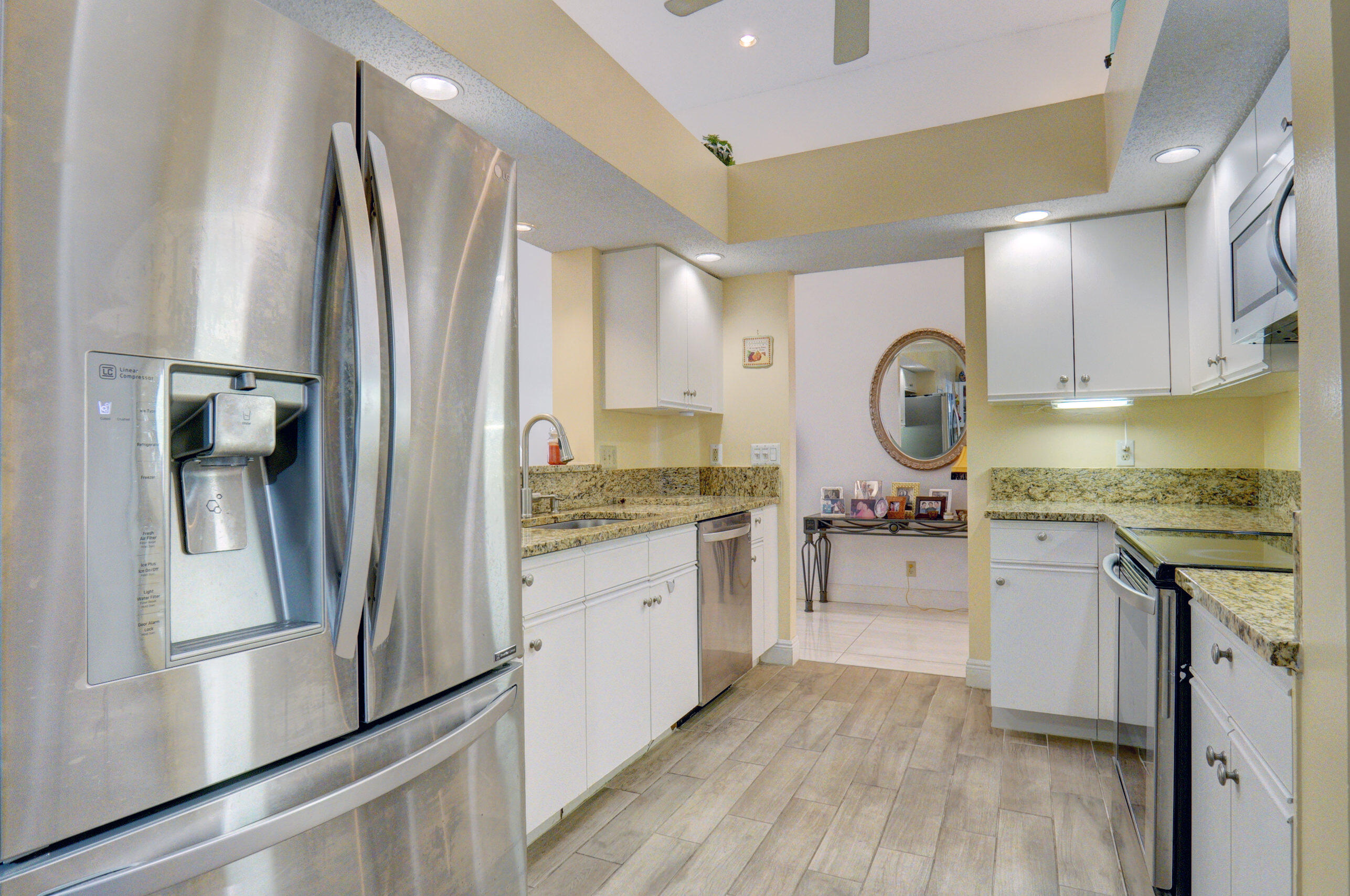 11110 Autoro Court Boca Raton, FL 33498 - Photo 3 of 24 a kitchen with a refrigerator and a stove