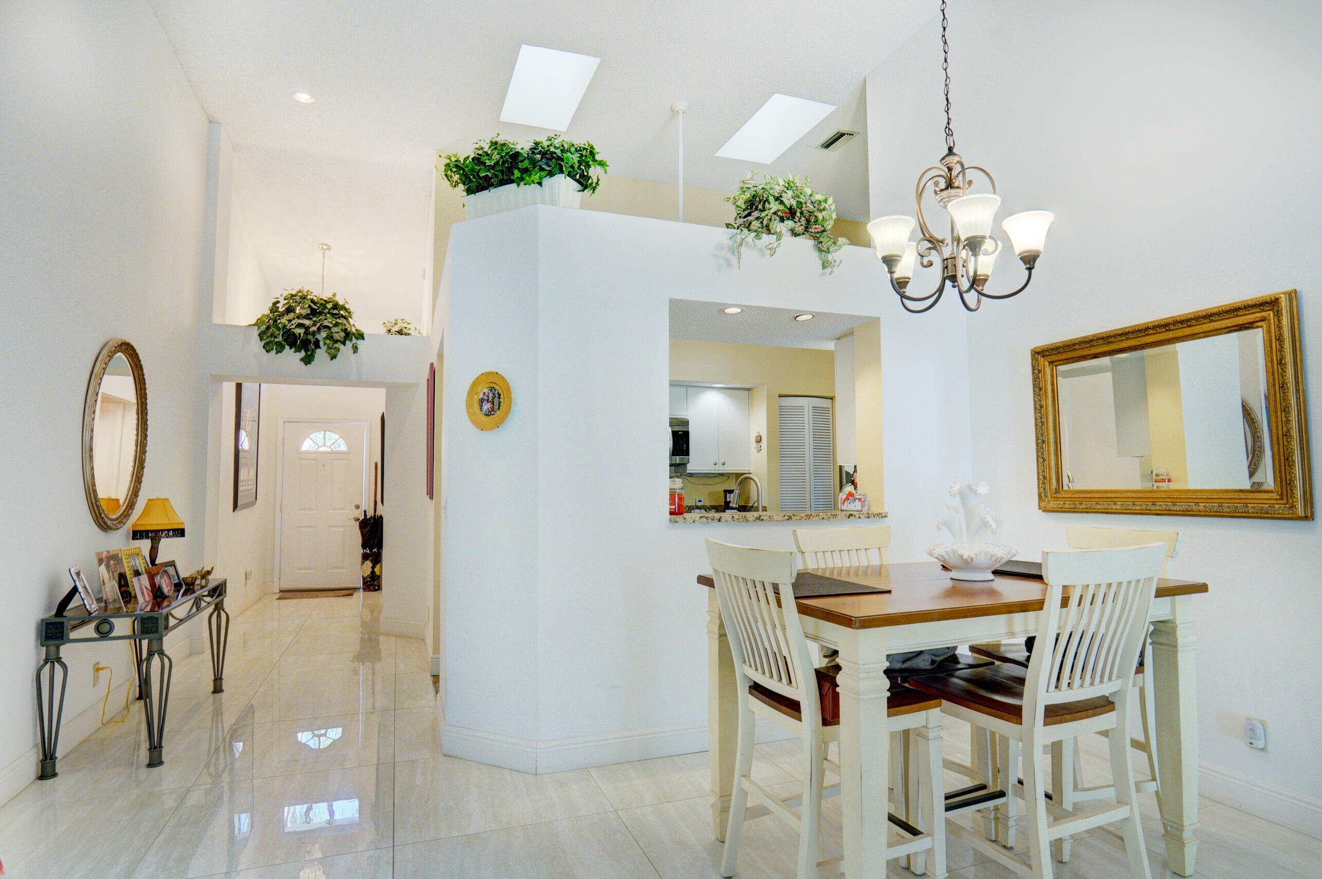 11110 Autoro Court Boca Raton, FL 33498 - Photo 10 of 24 a view of a dining room with furniture and chandelier