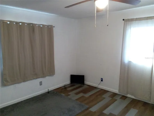 a view of a room with wooden floor
