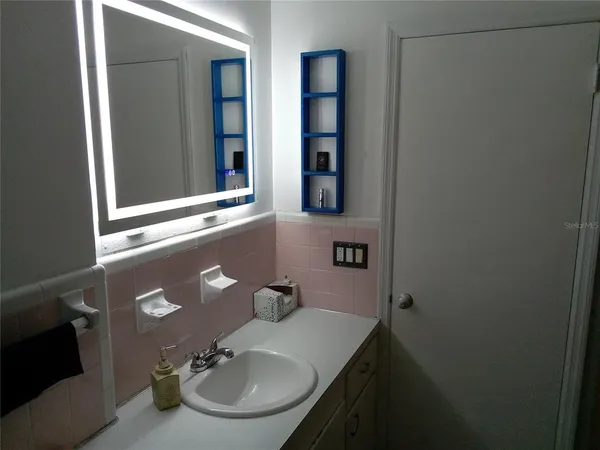 a bathroom with a sink and a mirror