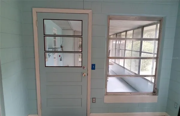 a view of a room with furniture and windows