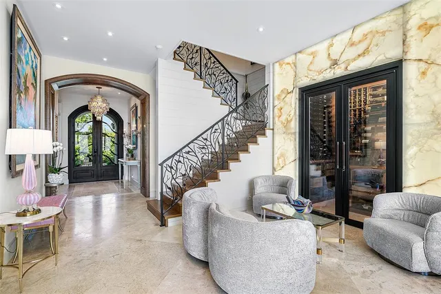 a living room with fireplace furniture and a large window
