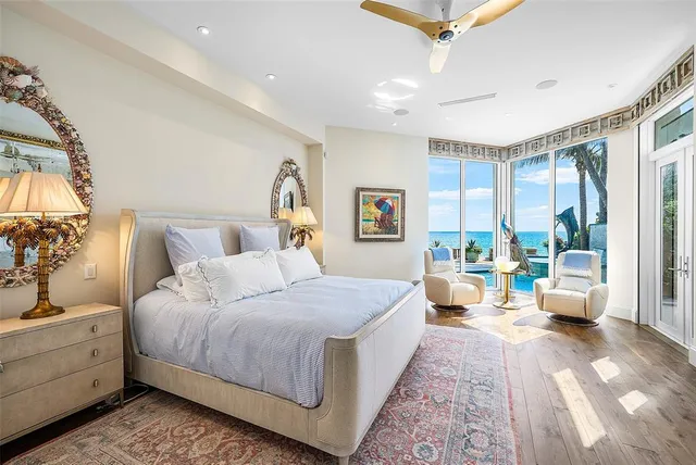a living room with furniture a flat screen tv and a floor to ceiling window