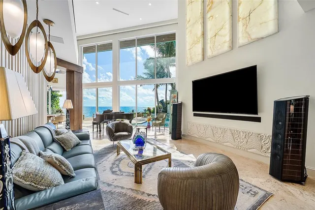 a dining room with furniture and a chandelier