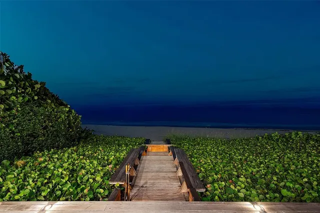 a view of a patio with couches and table and chairs and potted plants