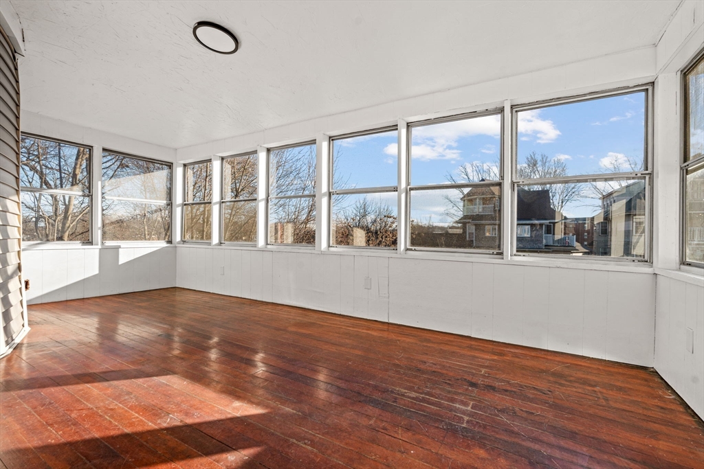 36 Elm Hill Park, Unit 1F Boston, MA 02121 - Photo 14 of 23 an empty room with wooden floor and windows