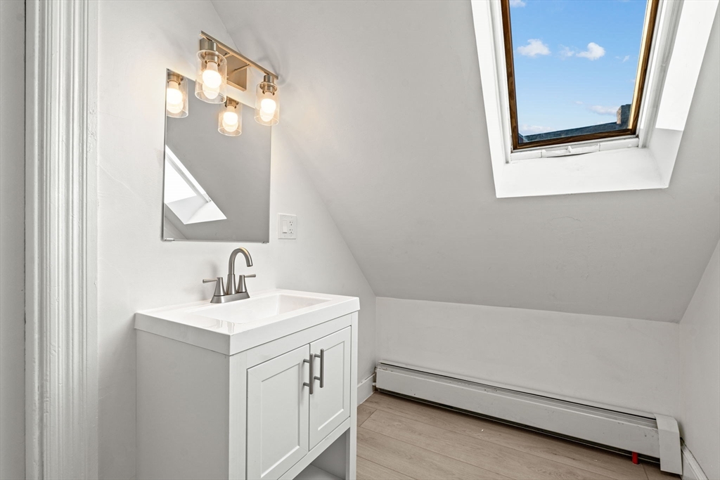 36 Elm Hill Park, Unit 1F Boston, MA 02121 - Photo 21 of 23 a bathroom with a sink a vanity and a mirror