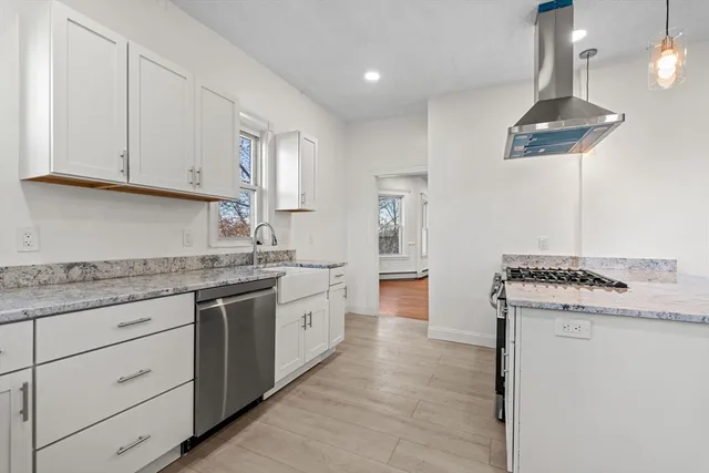 a kitchen with granite countertop a sink stainless steel appliances and cabinets