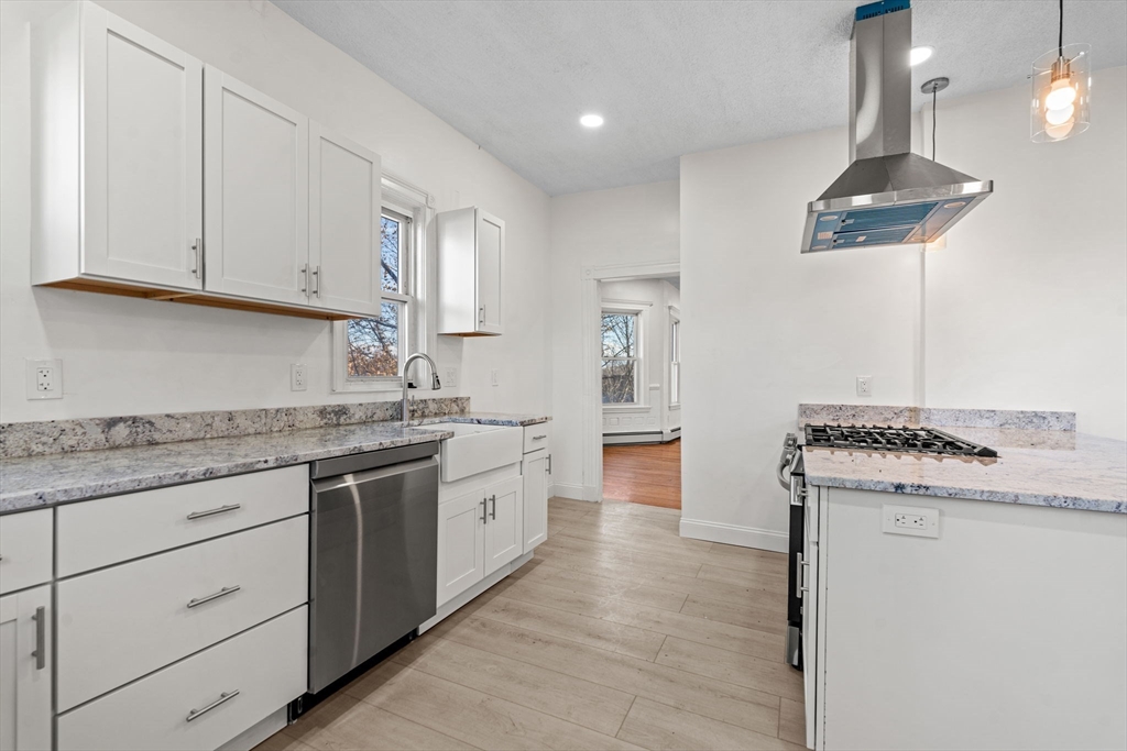 36 Elm Hill Park, Unit 1F Boston, MA 02121 - Photo 3 of 23 a kitchen with granite countertop a sink stainless steel appliances and cabinets