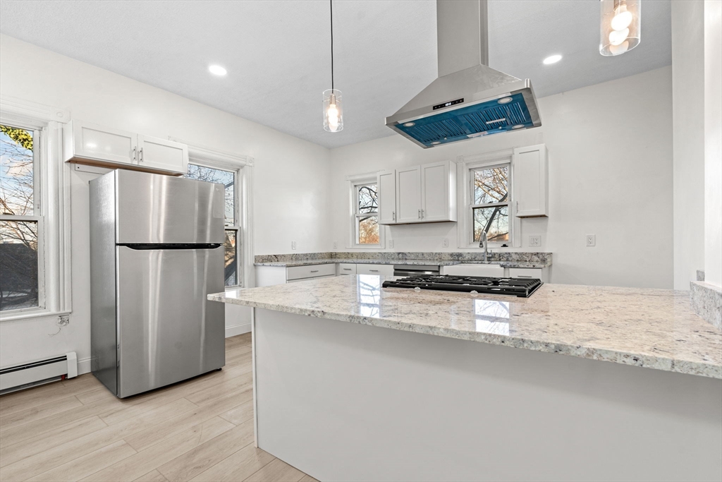 36 Elm Hill Park, Unit 1F Boston, MA 02121 - Photo 4 of 23 a kitchen with stainless steel appliances granite countertop a refrigerator a sink a stove a microwave and a refrigerator
