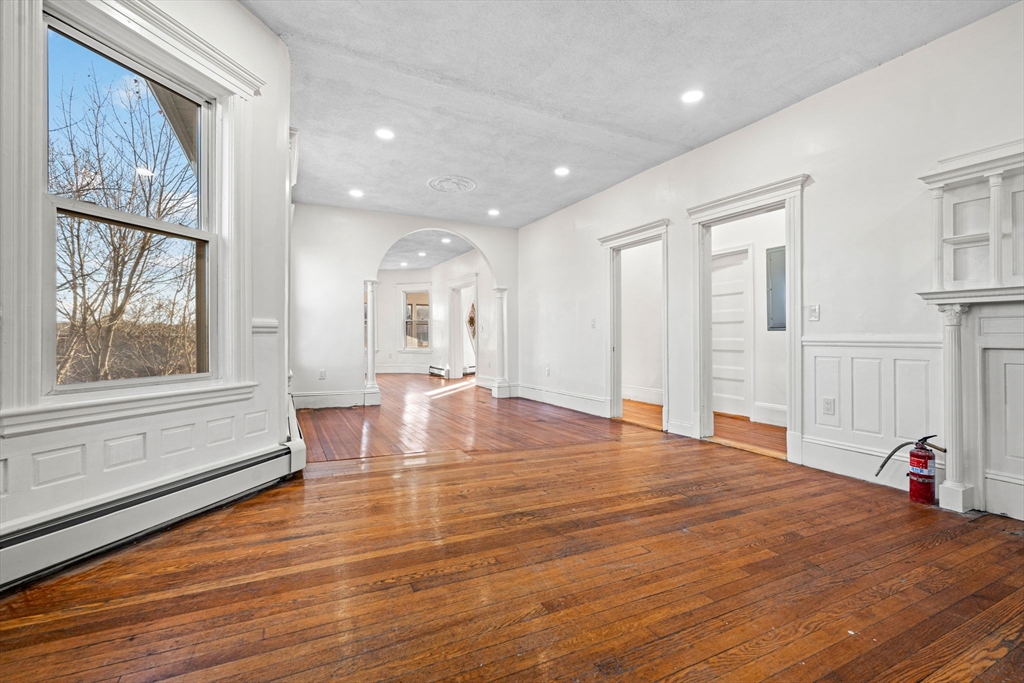 36 Elm Hill Park, Unit 1F Boston, MA 02121 - Photo 6 of 23 a large room with wooden floor and windows