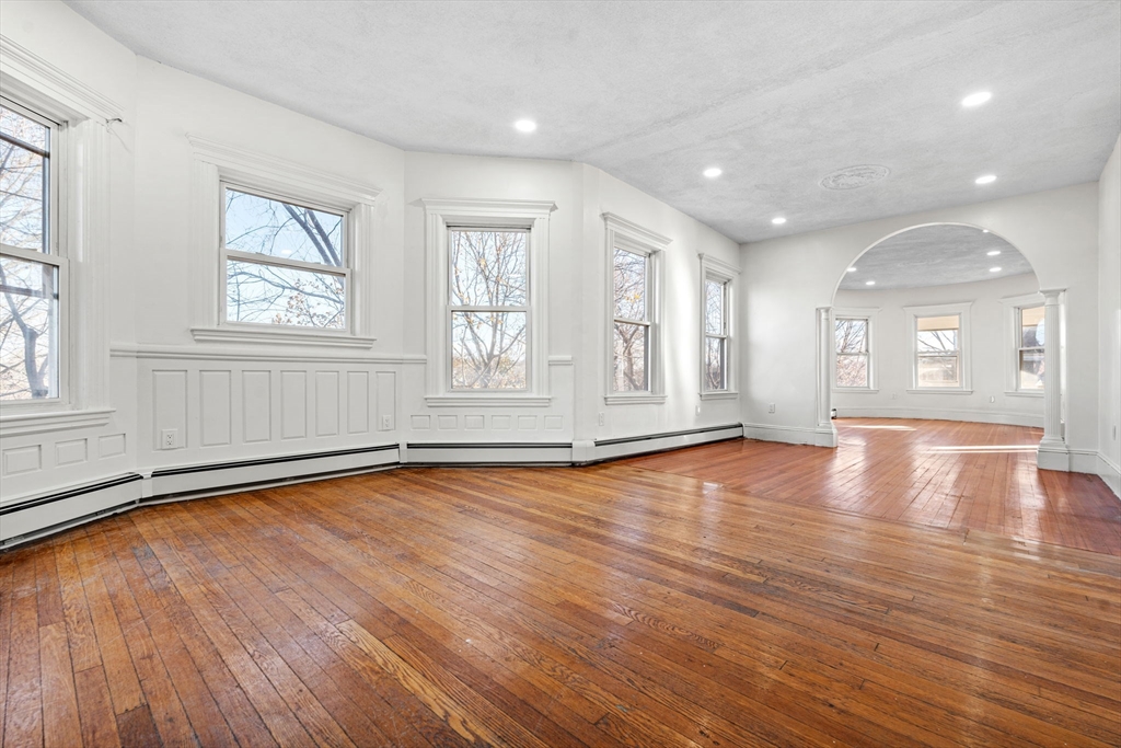 36 Elm Hill Park, Unit 1F Boston, MA 02121 - Photo 7 of 23 a view of an empty room with wooden floor and a window