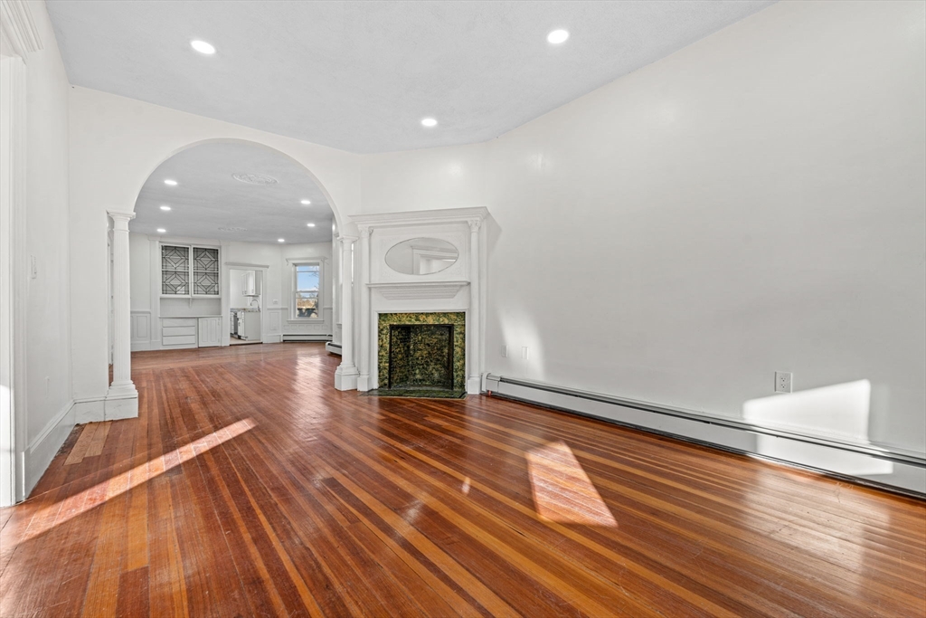 36 Elm Hill Park, Unit 1F Boston, MA 02121 - Photo 9 of 23 a view of a livingroom with wooden floor and a fireplace